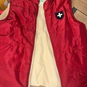 Boys size 6-7 Red Puffer Vest with Cream Lining and Shield Patch